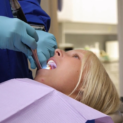 Dentist examining patient's mouth with intraoral camera