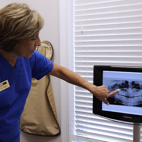 Doctor Jasper showing a patient their digital dental x rays