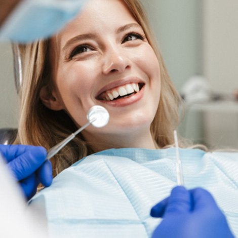 Woman smiling at dentist during checkup