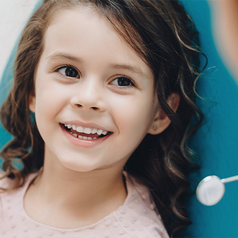 Little girl smiling in dental chair