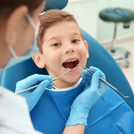 Young boy opening his mouth for a dental exam