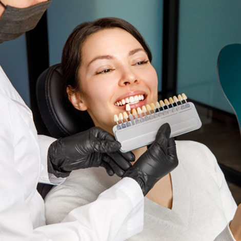 Woman smiling after learning the cost of cosmetic dentistry in Fort 
