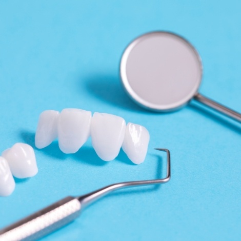 Dental veneers against light blue background