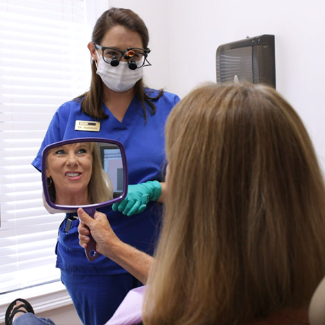 Dental patient seeing their smile after cosmetic dentistry in Fort Mill