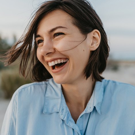 Smiling, happy woman standing outside