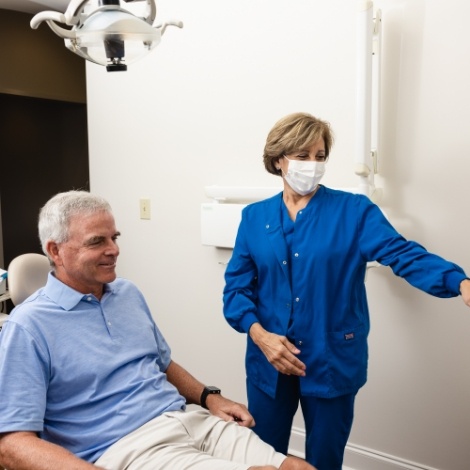 Dentist showing a patient something out of frame