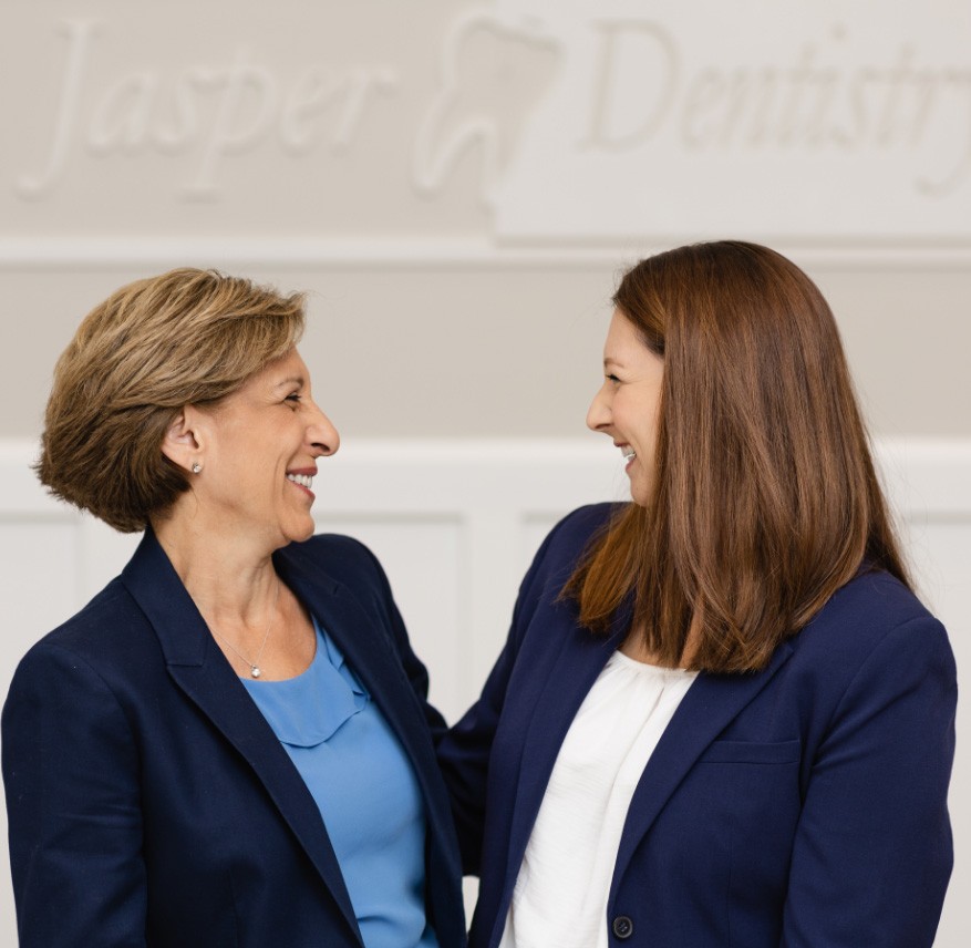 Fort Mill South Carolina dentists Doctor Jasper and Doctor Anderson smiling at each other