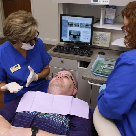 Dentists talking to dental patient about replacing missing teeth in Fort Mill
