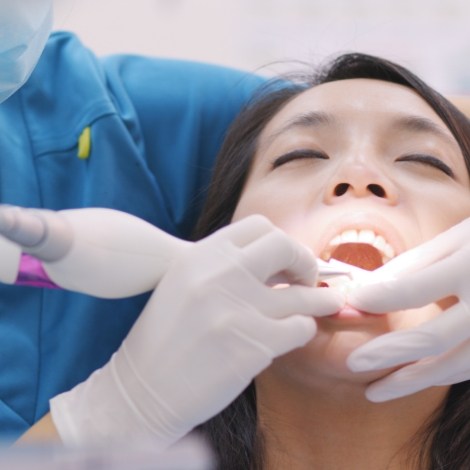Woman receiving scaling and root planing for gum disease treatment