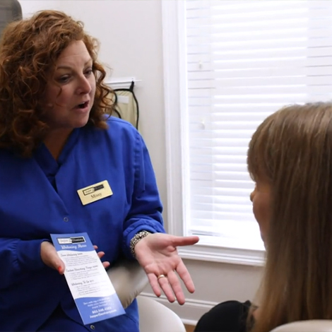 Dental team member talking to patient about Smile Savings Plan in Fort Mill