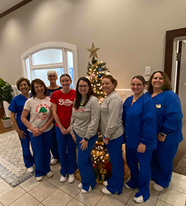 Jasper Dentistry team gathered around Christmas tree